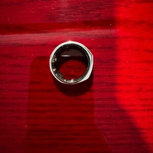 Oura generation 3 heritage ring. Charging base and charging cord included.